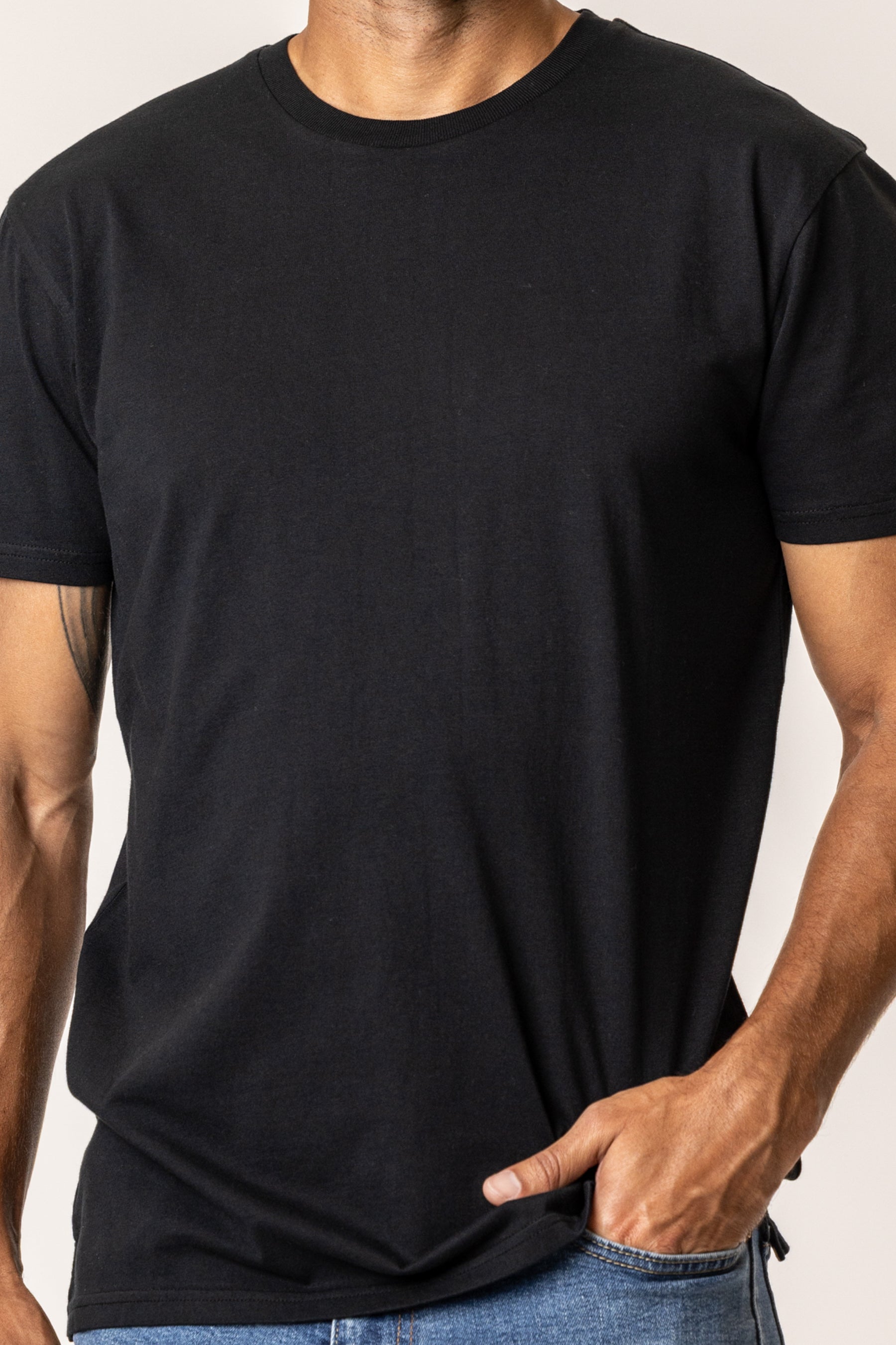 Person wearing a plain black t-shirt