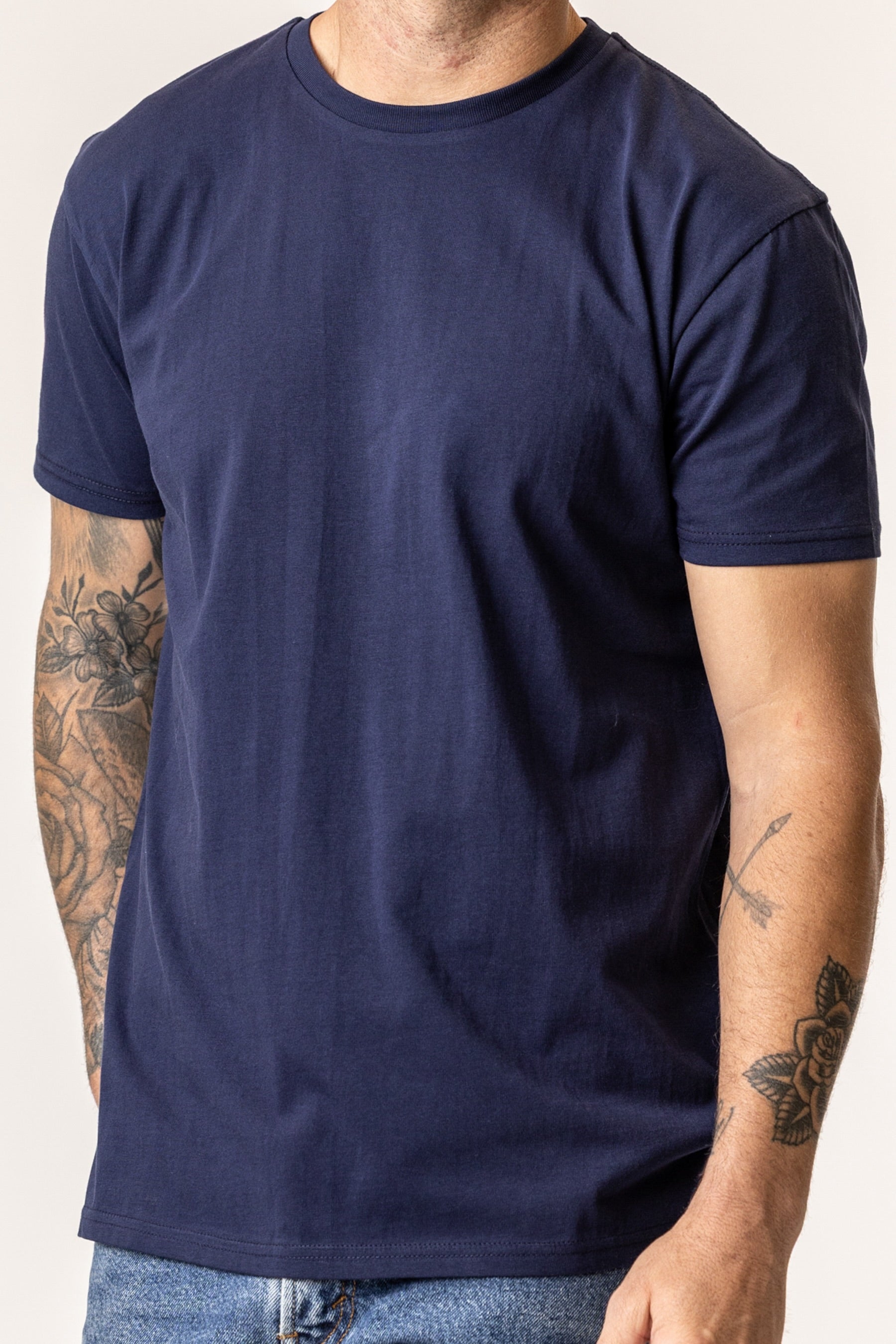 Person wearing a plain organic cotton navy blue t-shirt