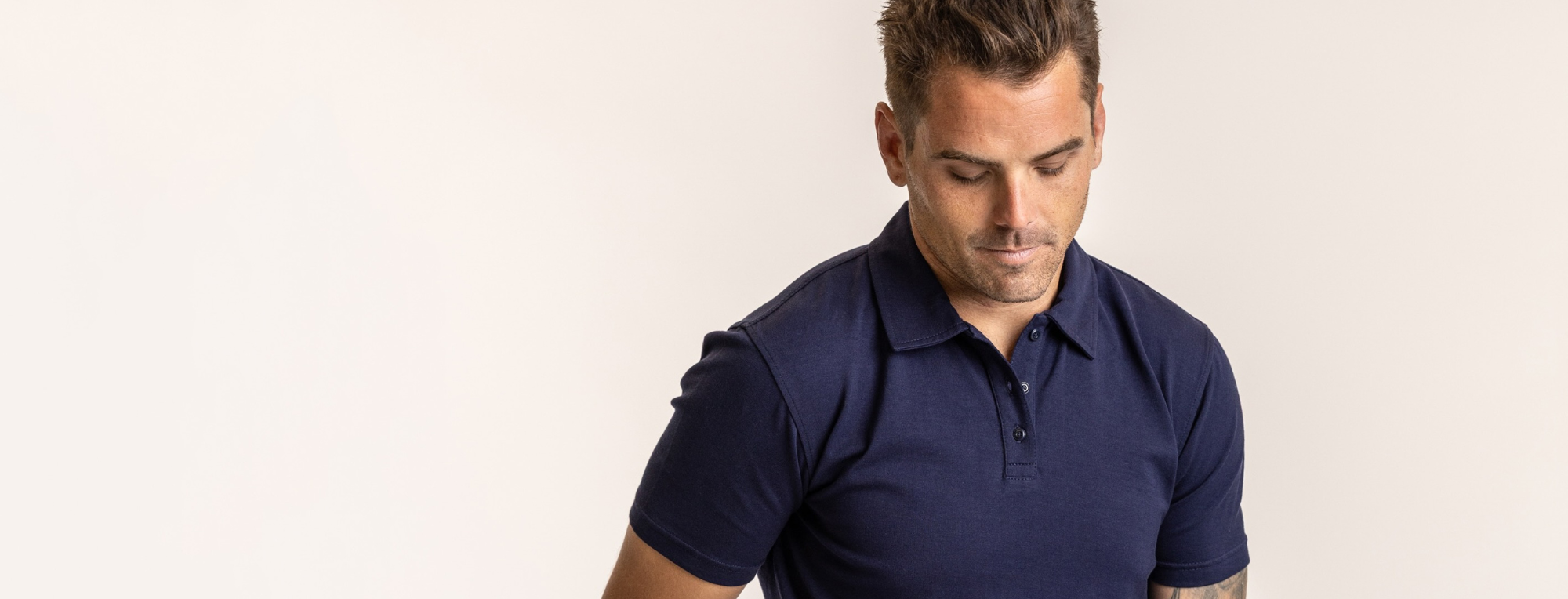 close up shot of navy blue polo shirt worn by a man